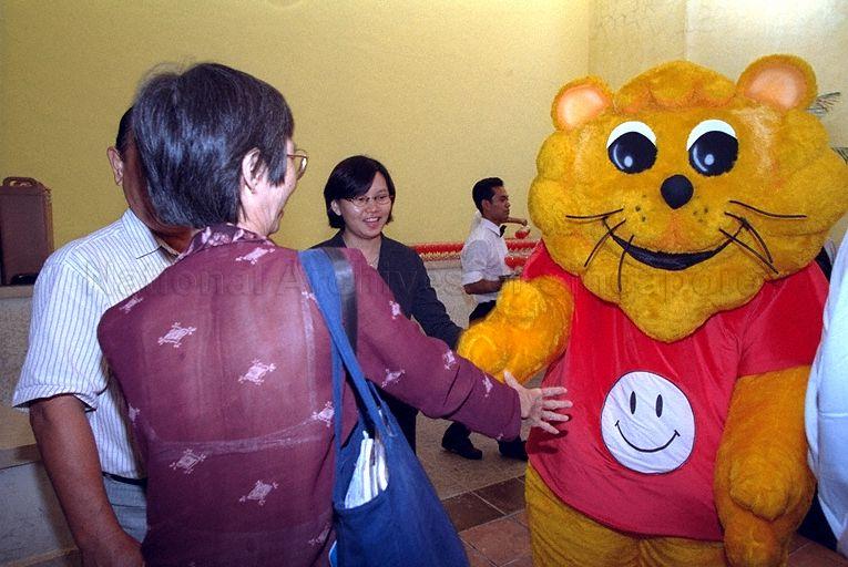 Guests being greeted by Singa the Courtesy Lion, mascot for Courtesy Campaign, during launch of 22nd National Courtesy Campaign at Golden Village Grand cinema complex, Great World City