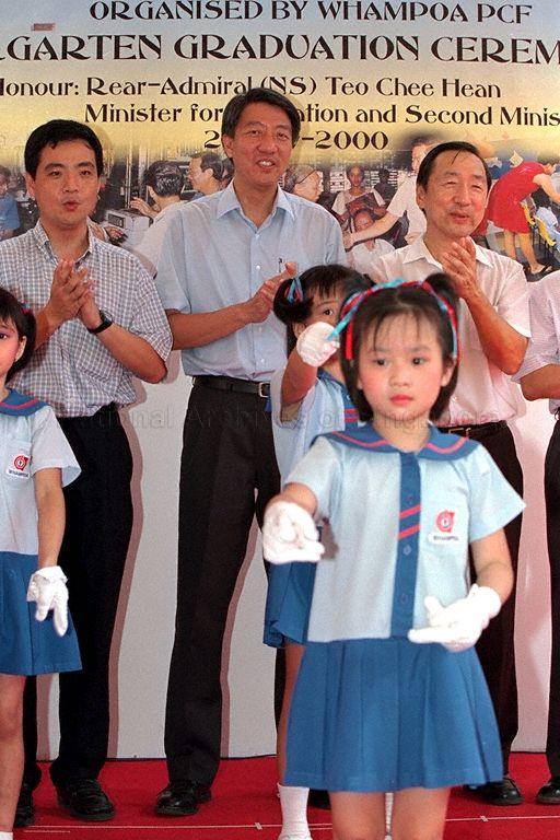 Minister for Education and Second Minister for Defence Rear Admiral Teo Chee Hean (centre), Member of Parliament for Bukit Timah Group Representation Constituency Dr Wang Kai Yuen (right) and Deputy Secretary General of National Trades Union Congress Heng Chee How (left) joining the children singing at Graduation Ceremony 2000 for Whampoa Division kindergarten