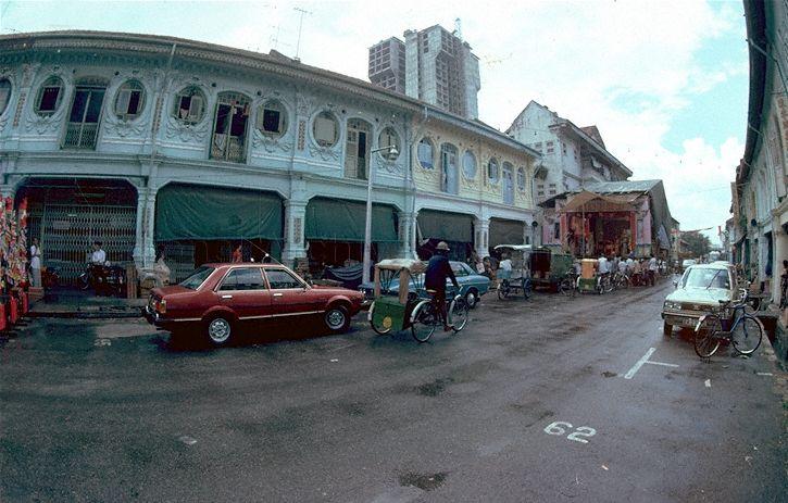 Windows featuring peranakan designs at shophouses located at Syed Alwi Road near the junction of Jalan Besar. The Housing and Development Board (HDB) flats at Rowell Road can be seen in the background.
