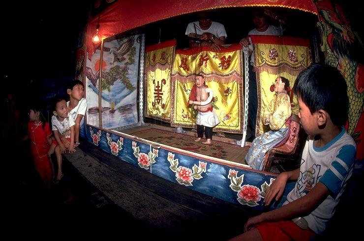 Children seated close to stage during string puppet (marionette) show