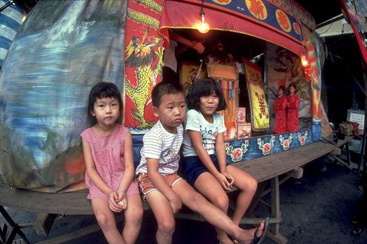 Children seated close to stage during string puppet (marionette) show