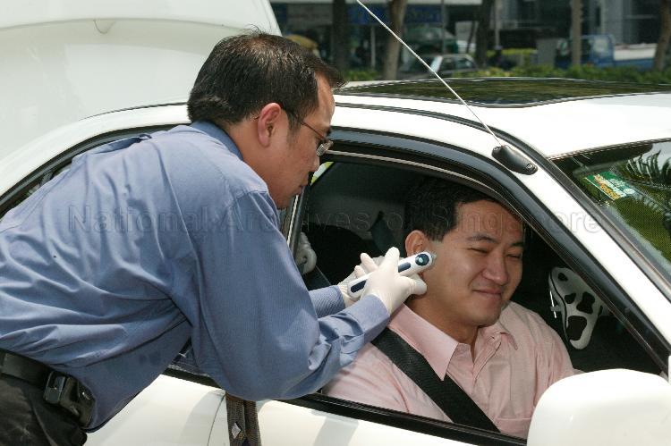 Non-Constituency Member of Parliament (NCMP) Steve Chia Kiah Hong having his temperature taken at Parliament House
