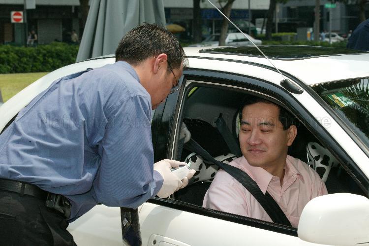 Non-Constituency Member of Parliament (NCMP) Steve Chia Kiah Hong having his temperature taken at Parliament House