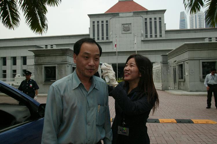 Opposition Member of Parliament for Hougang Low Thia Khiang having his temperature taken at Parliament House