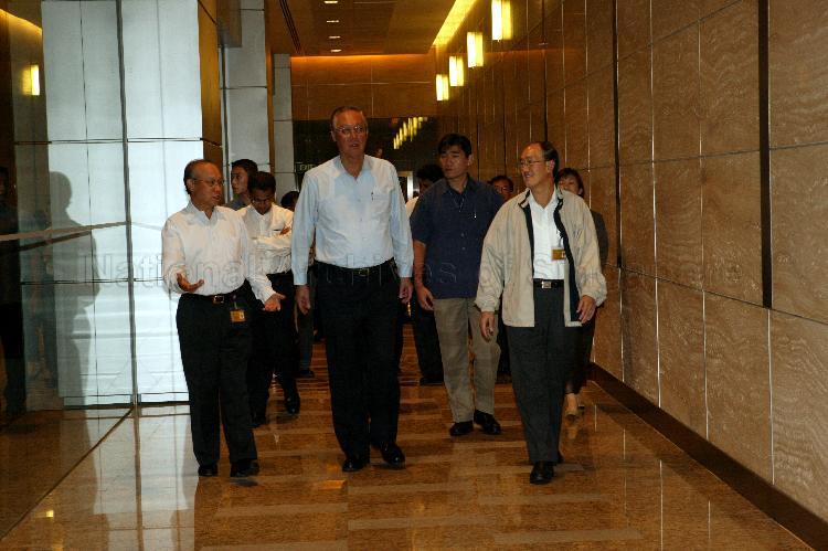 Prime Minister Goh Chok Tong, accompanied by Singapore Press Holdings' (SPH) Editor-in-Chief of English/Malay Newspapers Division Cheong Yip Seng (right) and Senior Executive Vice President of Chinese Newspapers and Newspaper Services Chew Keng Juea, leaving SPH News Centre in Toa Payoh after his visit to the media organisation for discussion with editors and journalists