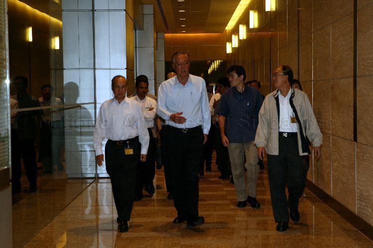 Prime Minister Goh Chok Tong, accompanied by Singapore Press Holdings' (SPH) Editor-in-Chief of English/Malay Newspapers Division Cheong Yip Seng (right) and Senior Executive Vice President of Chinese Newspapers and Newspaper Services Chew Keng Juea, leaving SPH News Centre in Toa Payoh after his visit to the media organisation for discussion with editors and journalists