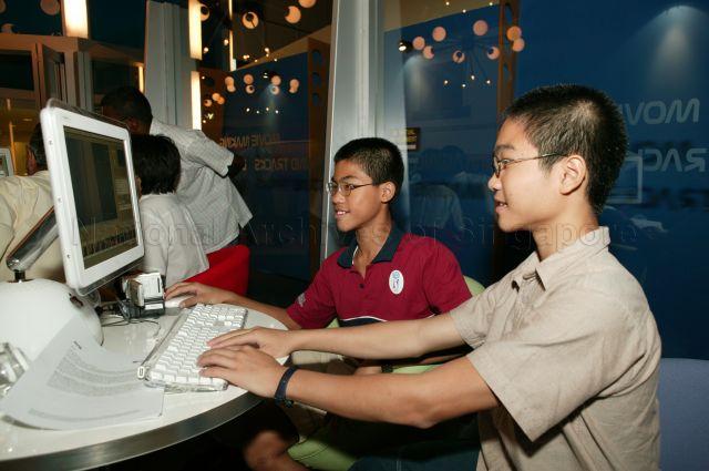 Two young visitors using the computer system at the exhibition during launch of E-celebrations 2003 and opening of the Infocomm Xperience at Singapore Science Centre