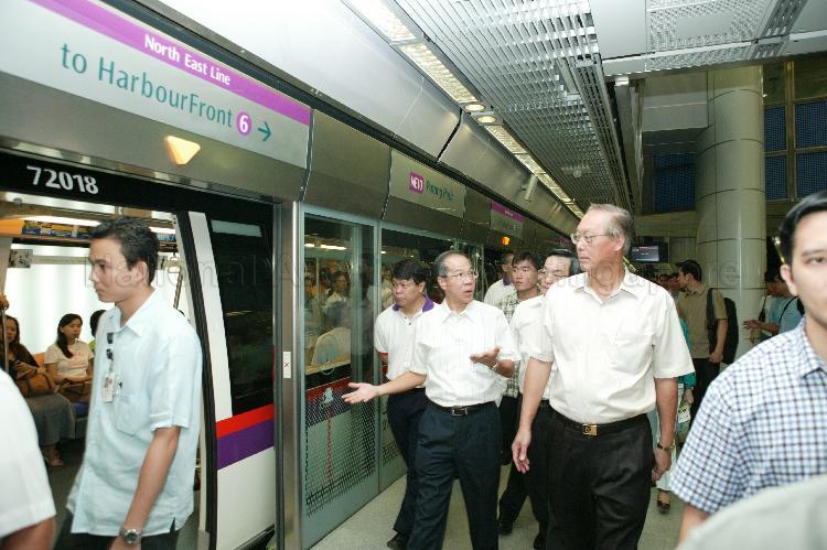 Prime Minister Goh Chok Tong and Minister for Transport Yeo Cheow Tong (left) on their way to board the train at Potong Pasir Mass Rapid Transit (MRT) station of the newly-opened North East Line (NEL)