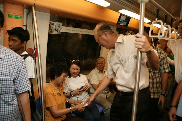 Prime Minister Goh Chok Tong and commuters talking while on board the train travelling between Potong Pasir and Chinatown Mass Rapid Transit (MRT) stations of the newly-opened North East Line (NEL)