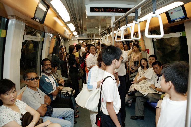 Commuters on board the train travelling between Potong Pasir and Chinatown Mass Rapid Transit (MRT) stations of the newly-opened North East Line (NEL)