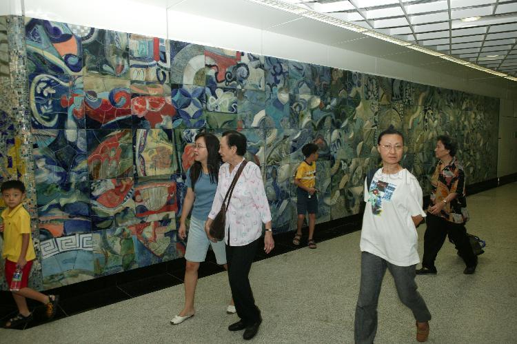 Commuters at Dhoby Ghaut Mass Rapid Transit (MRT) interchange station of the newly-opened North East Line (NEL). A large mural decorated the walls in the MRT station.
