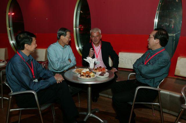 From left, Permanent Secretary to Ministry of Information, Communications and the Arts (MICA) Dr Tan Chin Nam, guest of honour Minister for Information, Communications and the Arts Dr Lee Boon Yang, Asia Pacific leader of Entertainment and Media Practice at Pricewaterhouse Coopers Marcel Fenez and Chief Executive Officer of MediaCorp Ernest Wong in conversation at lounge of Zouk in Jian Kim Street during Media 21 Industry Forum "Co-Creating the Future: Singapore as a Global Media City".