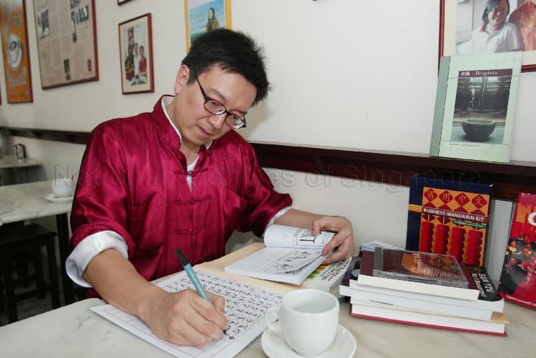 Man writing Chinese manuscripts at Ya Kun Kaya Toast Coffee Stall before official launch of Speak Mandarin Campaign at Mox Bar and Cafe, 21 Tanjong Pagar Road