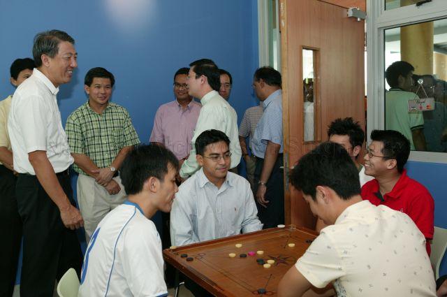 Minister for Defence Rear Admiral Teo Chee Hean (left) and Member of Parliament for Ang Mo Kio Group Representation Constituency Wee Siew Kim (second from left) watching residents playing carom during visit to Jalan Kayu Division of Ang Mo Kio Group Representation Constituency