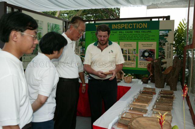Prime Minister Goh Chok Tong being briefed by Director of Arboriculture, National Parks Board, Simon Longman (right) when he tours exhibition during Clean and Green Carnival organised by Marine Parade Town Council at Aljunied Crescent. Looking on is Member of Parliament for Marine Parade Group Representation Constituency Mrs Lim Hwee Hua (second from left).