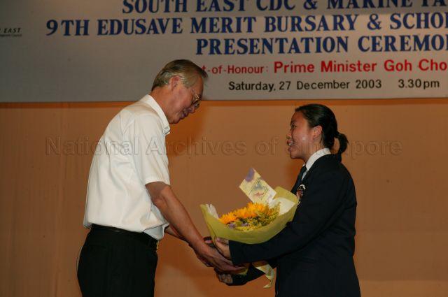Student from CHIJ Katong Convent presenting a bouquet of flowers to Prime Minister Goh Chok Tong after he presented bursaries and scholarship awards to students during South East Community Development Council and Marine Parade Citizens' Consultative Committee 9th Edusave Merit Bursary and Scholarship Awards Presentation Ceremony held at the school.
