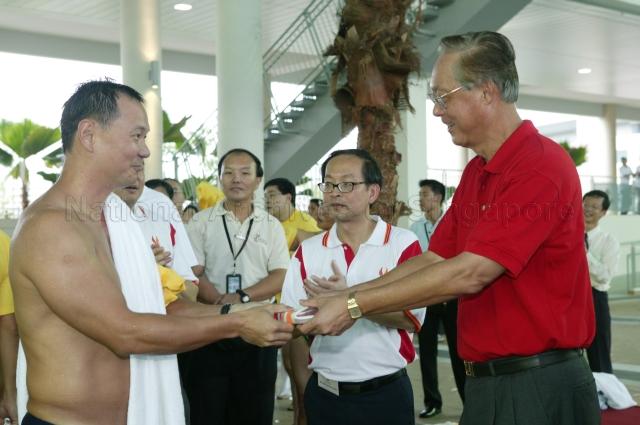 Prime Minister Goh Chok Tong presenting memento to swimming coach Ang Peng Siong who participated in a swimming race during official opening of Singapore Sports School at Champions Way, Woodlands. Looking on is Principal Moo Soon Chong