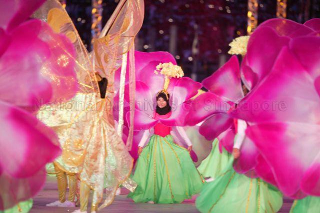 National Day Parade 2004 Preview at National Stadium -- Mass display performance by People's Association (PA). The music and dance extravaganza involves 850 members, some dressed as flowers, leaves and butterflies, and huge colourful props to represent flourishing garden city of Singapore.