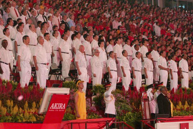 National Day Parade 2004 at the National Stadium -- View of President S R Nathan, Prime Minister Goh Chok Tong, Deputy Prime Minister and Minister for Finance Lee Hsien Loong, Minister for Law and Foreign Affairs Professor S Jayakumar, Senior Minister Lee Kuan Yew, Deputy Prime Minister and Coordinating Minister for Security and Defence Dr Tony Tan, Minister in the Prime Minister's Office and Second Minister for Foreign Affairs Lee Yock Suan, Minister for Transport Yeo Cheow Tong, Minister for Information, Communications and the Arts Dr Lee Boon Yang, Minister in the Prime Minister's Office Lim Boon Heng, Minister for Defence Teo Chee Hean, Minister for Community Development and Sports and Minister in-charge of Muslim Affairs Dr Yaacob Ibrahim, Minister for Education Tharman Shanmugaratnam, Senior Minister of State in the Prime Minister's Office Matthias Yao, Senior Minister of State for Law and Home Affairs Associate Professor Ho Peng Kee, Minister of State for Health and Transport Dr Balaji Sadasivan, Minister of State for Trade and Industry Dr Vivian Balakrishnan and members of Parliament singing the national anthem at the grandstand