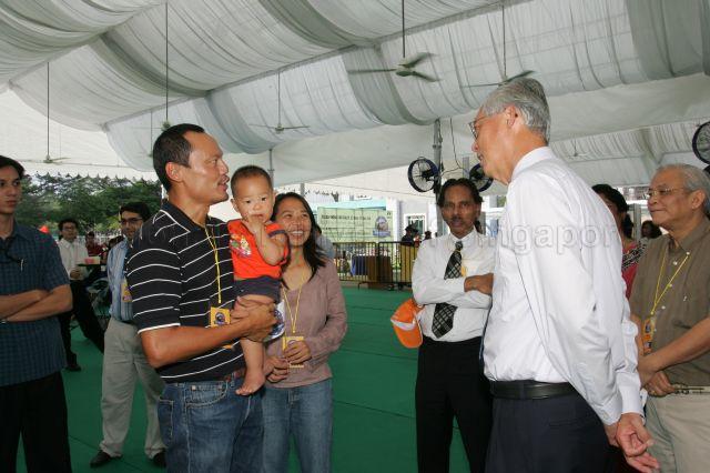 Senior Minister Goh Chok Tong chatting with Khoo Swee Chiow, the first Singaporean to reach the Summit of Mount Everest in 1998, and Mrs Khoo during Welcome Carnival for participants of First ASEAN-India Car Rally at Singapore Recreation Club at the Padang