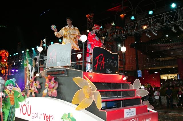 Float featuring "PAssion Card" a community privilege card issued by People's Association (PA) driving through Orchard Road during Chingay 2005 procession. Chingay 2005 with the theme 'Parade of Dreams' was attended by Guest-of-Honour President S R Nathan and his wife.
