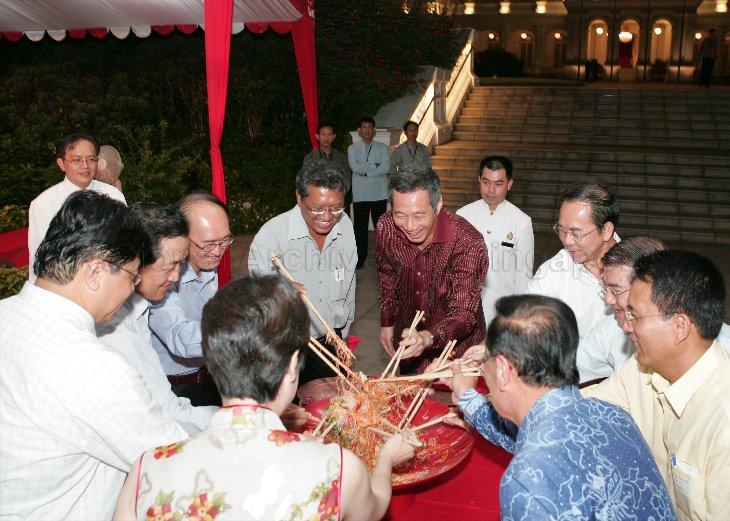 Guest-of-Honour Prime Minister and Minister for Finance Lee Hsien Loong (in maroon shirt) tossing yu sheng (raw fish) with guests during Chinese New Year (Chap Goh Mei) reception at Istana