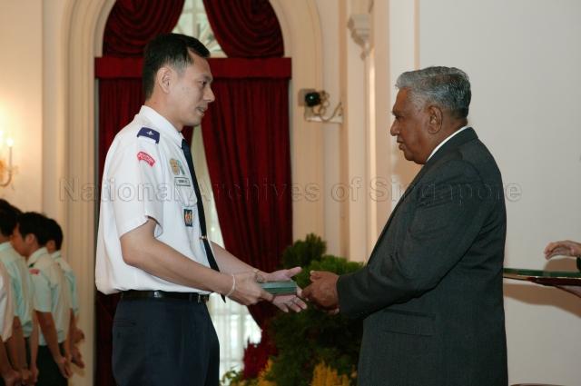 President and Singapore's Chief Scout S R Nathan presenting Chief Scout's Commendation to Edwin Lye Teck Hee at Scouts Good Service Awards 2004 Ceremony held in Istana State Room