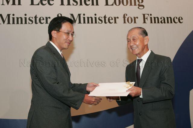 Chairman of the Public Service Commission Dr Andrew Chew Guan Khuan presenting certificate of appointment/promotion to Chief Executive of SPRING Singapore Loh Khum Yean during annual dinner for the Administrative Service, the Civil Service's elite wing, at Conrad Centennial Singapore. Guest of Honour at the dinner was Prime Minister and Minister for Finance Lee Hsien Loong.