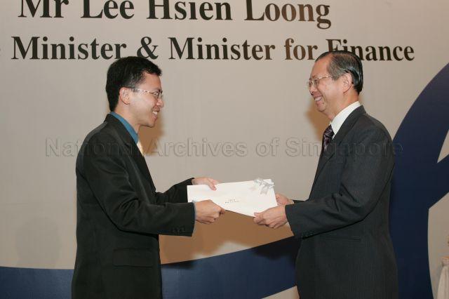 Permanent Secretary to Ministry of Finance and outgoing Head of Civil Service Lim Siong Guan presenting certificate of appointment/promotion to Director (Operations) of Singapore Police Force, Ministry of Home Affairs, Aubeck Kam Tse Tsuen during annual dinner for the Administrative Service, the Civil Service's elite wing, at Conrad Centennial Singapore. Guest of Honour at the dinner was Prime Minister and Minister for Finance Lee Hsien Loong.