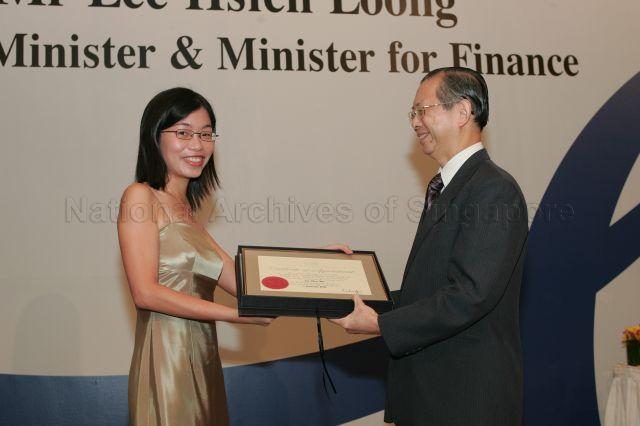 Permanent Secretary to Ministry of Finance and outgoing Head of Civil Service Lim Siong Guan presenting certificate of appointment/promotion to Assistant Director (Management Information/Planning), Ministry of Education, Ms Lee Shiao Wei during annual dinner for the Administrative Service, the Civil Service's elite wing, at Conrad Centennial Singapore. Guest of Honour at the dinner was Prime Minister and Minister for Finance Lee Hsien Loong.