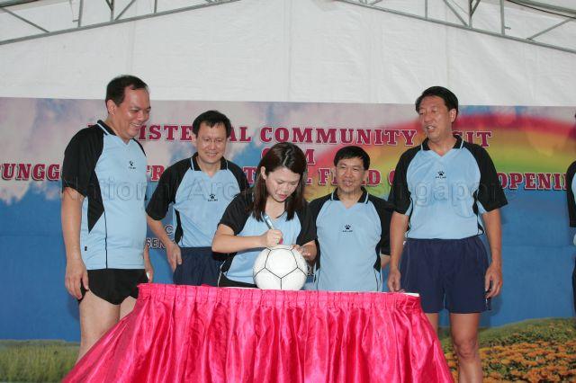 Member of Parliament (MP) for Pasir Ris-Punggol Group Representation Constituency (GRC) Miss Penny Low autographing on a football during Acting Second Minister for Finance and Senior Minister of State for Foreign Affairs Raymond Lim's (second from left) during his community visit to Punggol Central cum official opening of Punggol Central football field. Also looking on are MPs for Pasir Ris-Punggol GRC Charles Chong (left), Dr Michael Lim (second from right) and &nbsp;Minister for Defence Teo Chee Hean (right).