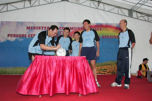 Member of Parliament (MP) for Pasir Ris-Punggol Group Representation Constituency (GRC) Charles Chong autographing on a football during Acting Second Minister for Finance and Senior Minister of State for Foreign Affairs Raymond Lim's (fourth from right) during his community visit to Punggol Central cum official opening of Punggol Central football field. Also looking on from right are, Chief Executive Director of People's Association Tan Boon Huat, MPs for Pasir Ris-Punggol GRC Minister for Defence Teo Chee Hean and Dr Michael Lim.