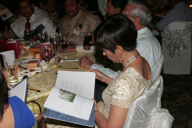 Member of Parliament for Tanjong Pagar Group Representation Constituency Ms Indranee Rajah reading through the commemorative book &#34;Saadara-PraNaama (Respectful Salutation) : Indian Community Tribute to Senior Minister Goh Chok Tong&#34; during the Indian Community Dinner at Ritz Carlton Hotel which is attended by guest of honour Senior Minister Goh Chok Tong