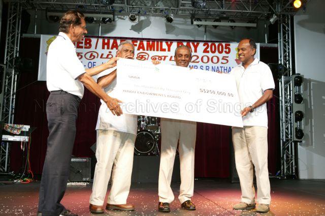 From left, Chairman of Hindu Endowments Board (HEB) V R Nathan, guest of honour President S R Nathan, Deputy Prime Minister and Minister for Law Professor S Jayakumar, &nbsp;and Member of Parliament for Sembawang K Shanmugam holding the cheque of $250,000 raised by temples under HEB for Singapore Indian Development Association (SINDA) during HEB's family day cum awards ceremony at National Trades Union Congress (NTUC) Club, Downtown East