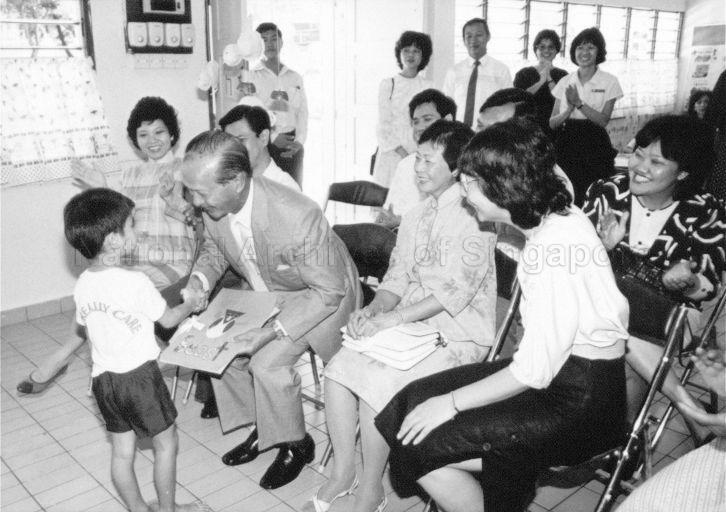 President Wee Kim Wee talking to a child while Mrs Wee (on President's left) looks on during their visit to National Trades Union Congress' Ang Mo Kio Child Care Centre