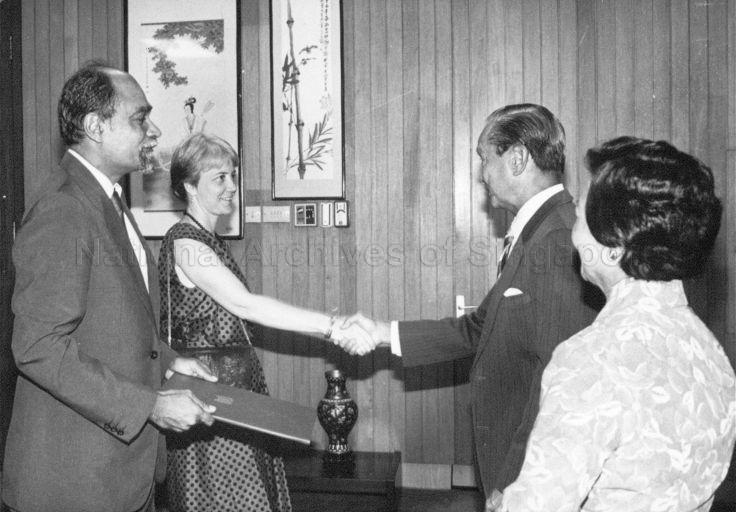 President Wee Kim Wee exchanging handshakes with Dr Sharon Siddique, wife of Singapore Ambassador-Designate to the Federal Republic of Germany Kemal Siddique (left) when he receives his letters of recall and credence at the Istana. Looking on is Mrs Wee.