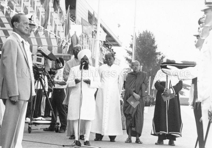 President Wee Kim Wee inaugurating the Singapore Armed Forces (SAF) flag at the SAF Day Parade at Pulau Brani Naval Base. The flag is being consecrated by representatives of Sikhism, Hinduism, Christianity, Buddhism and Islam.