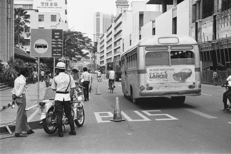 The first reserved bus lanes in operation along Robinson and Maxwell Road, in February 1974