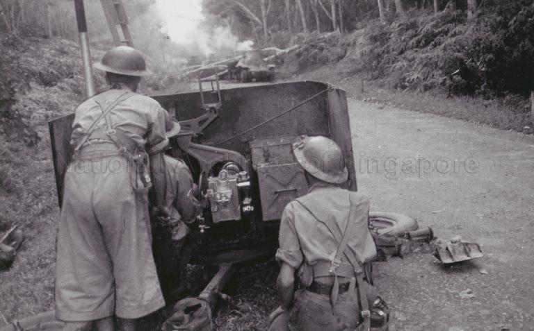 Three Australian soldiers of the 13th Battery, 4th Australian Anti-Tank Regiment and their two pounder anti-tank guns in ambush during Battle of Muar at Bakri, Malaya. They were responsible for destroying advancing Japanese Type 95 tanks.