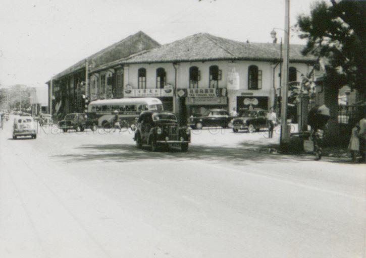 Picture shows junction of Yio Chu Kang Road and Upper Serangoon Road. On the right at the corner are the Paya Lebar Post Office and the Government Dispensary.