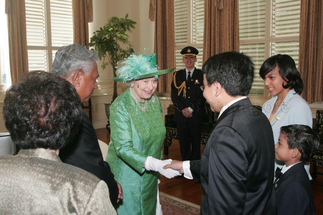 Her Majesty Queen Elizabeth II being introduced to President S R Nathan's grandson Kiron Cheong during her visit to Istana
