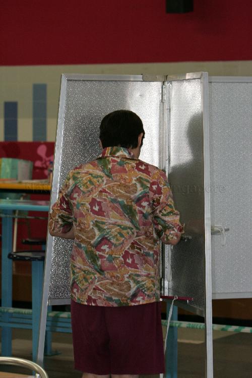 Voter marking ballot paper at the polling place at Bedok View Secondary School where the polling station is situated during Singapore General Election