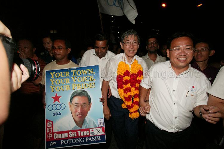 Singapore Democratic Alliance (SDA) candidate for Potong Pasir Chiam See Tong (garlanded) and supporters after his victory during Singapore General Election