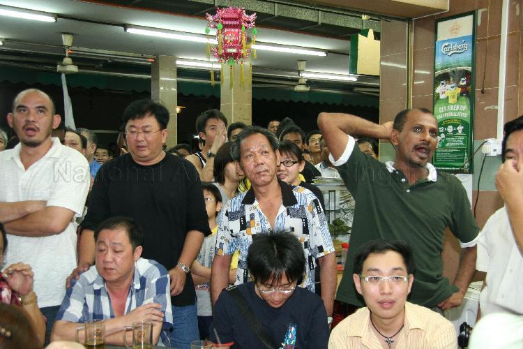 Singapore Democratic Alliance (SDA) supporters gathering at Jin Biao Coffeeshop at Block 136, Potong Pasir Avenue 3, to watch live coverage of election results. The coffeeshop was assembly centre for SDA and their supporters while waiting for election results during Singapore General Election.
