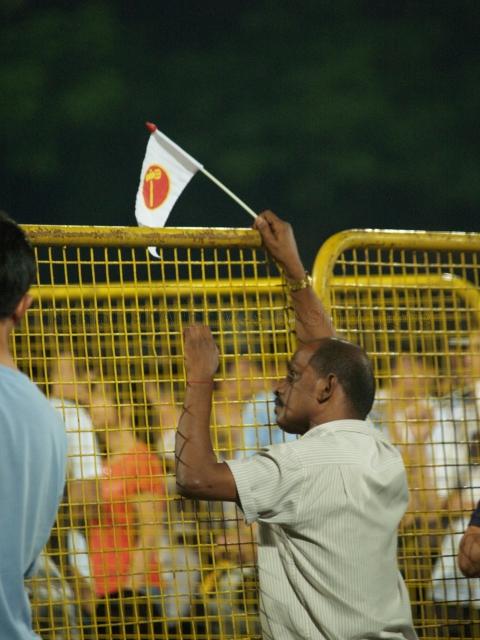 Supporter holding Workers' Party (WP) flag at Yio Chu Kang stadium, the assembly centre for WP and their supporters during Singapore General Election