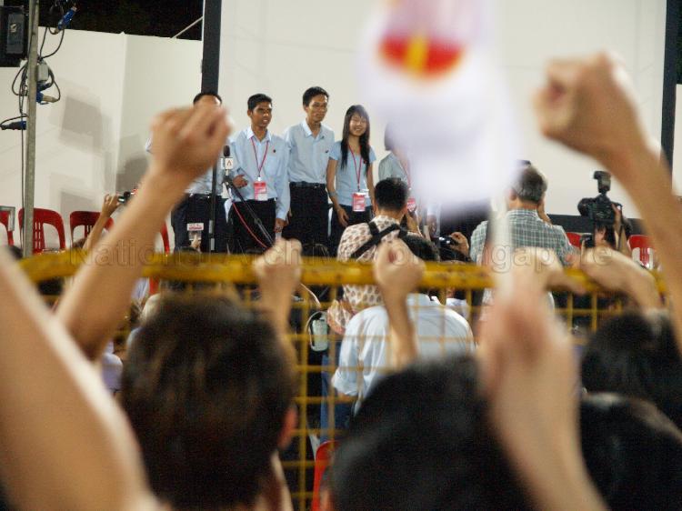 Workers' Party (WP) candidates for Ang Mo Kio Group Representation Constituency (GRC) on the stage to address supporters at Yio Chu Kang stadium, the assembly centre for WP and their supporters while waiting for election results during Singapore General Election