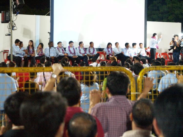 Workers' Party (WP) candidates seated on the stage at Yio Chu Kang stadium, the assembly centre for WP and their supporters while waiting for election results during Singapore General Election