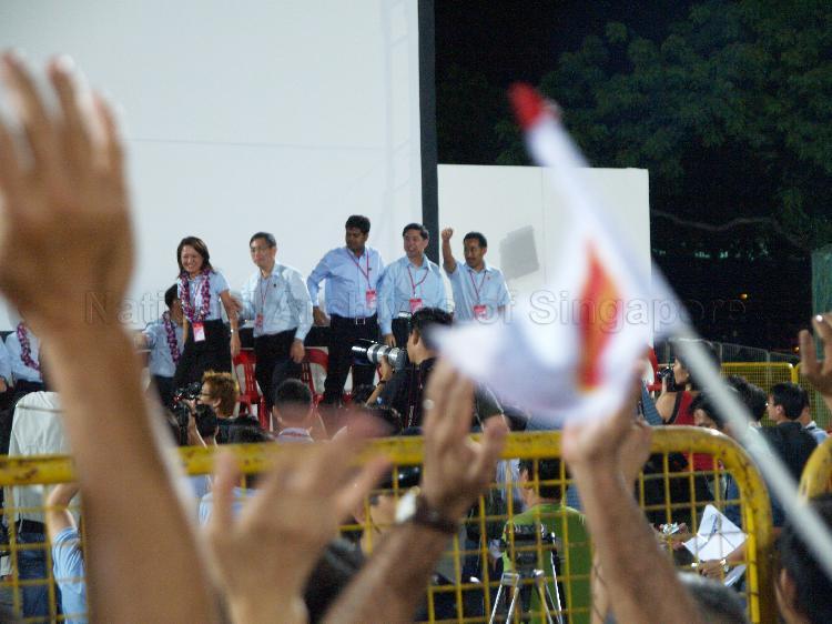 Workers' Party (WP) candidates for Aljunied Group Representation Constituency (GRC), from left, Ms Sylvia Lim Swee Lian, Goh Meng Seng, James Gomez, Tan Wui Hua and Mohammed Rahizan bin Yaacob on the stage to address supporters at Yio Chu Kang stadium. The stadium was assembly centre for WP and their supporters while waiting for election results during Singapore General Election.