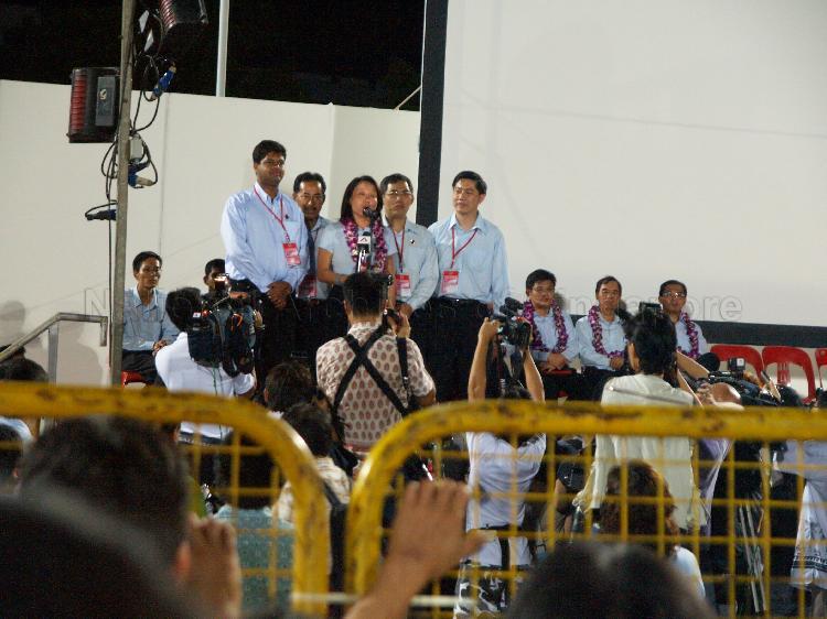 Workers' Party (WP) candidate for Aljunied Group Representation Constituency (GRC) Ms Sylvia Lim Swee Lian addressing supporters  at Yio Chu Kang stadium with her GRC team members (from left) James Gomez, Mohammed Rahizan Bin Yaacob, Goh Meng Seng and Tan Wui Hua looking on. The stadium was assembly centre for WP and their supporters while waiting for election results during Singapore General Election.