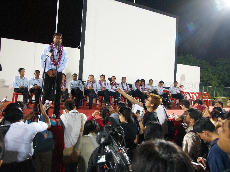 Workers' Party (WP) candidate for Aljunied Group Representation Constituency (GRC) James Gomez addressing supporters at Yio Chu Kang stadium with other WP candidates (seated) looking on. The stadium was assembly centre for WP and their supporters while waiting for election results during Singapore General Election.